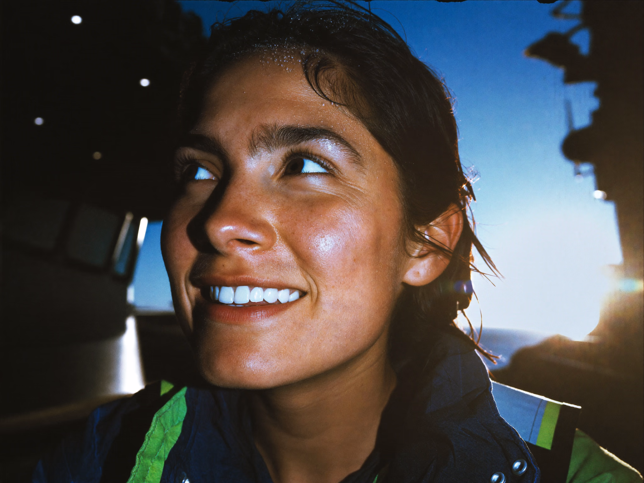 Maritime worker smiling, backlit by the sun