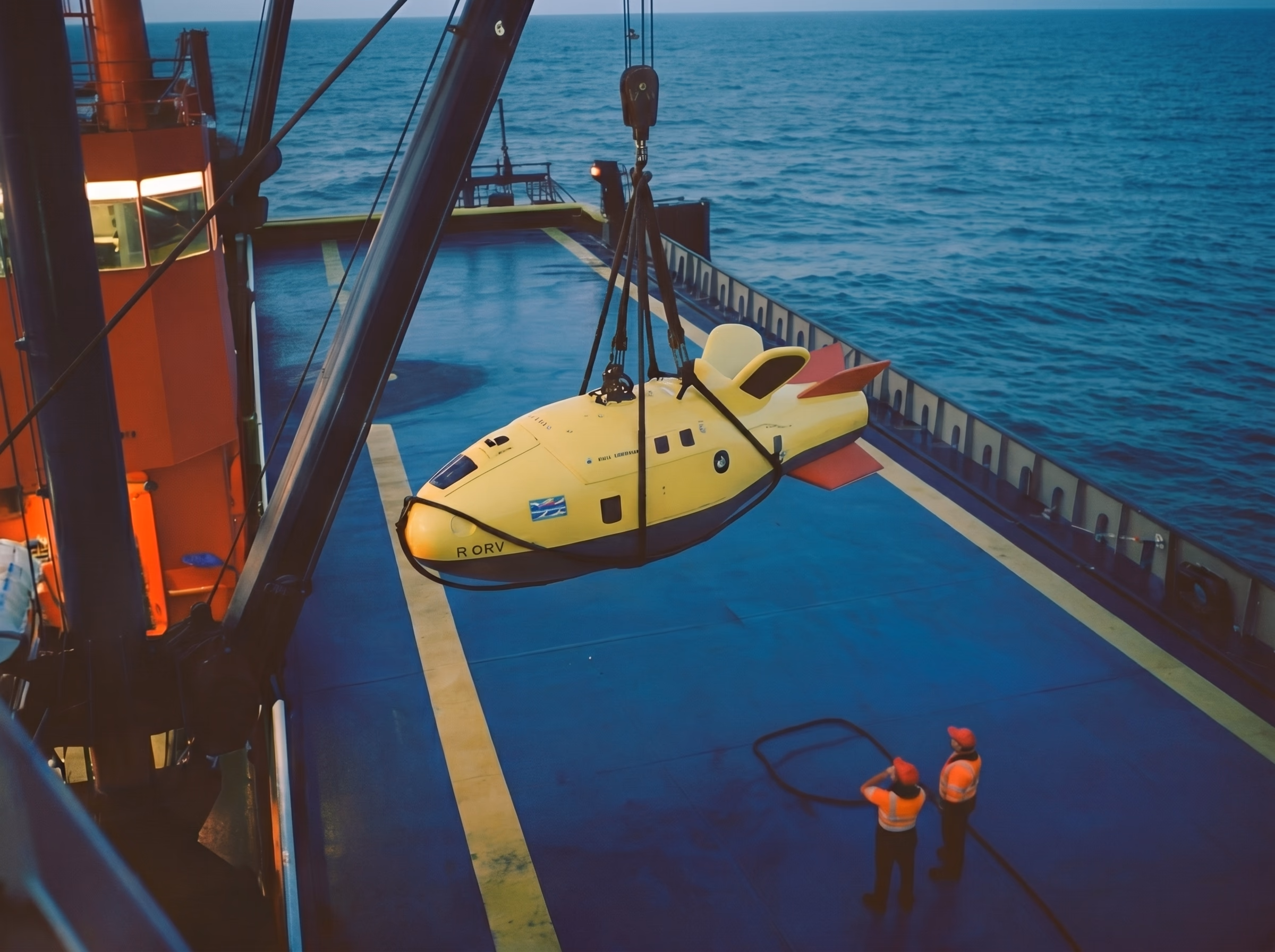 Submersible being lifted by a crane on a ship deck